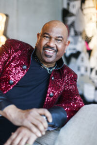 Singer and songwriter David E. Moore in a red sequined jacket.